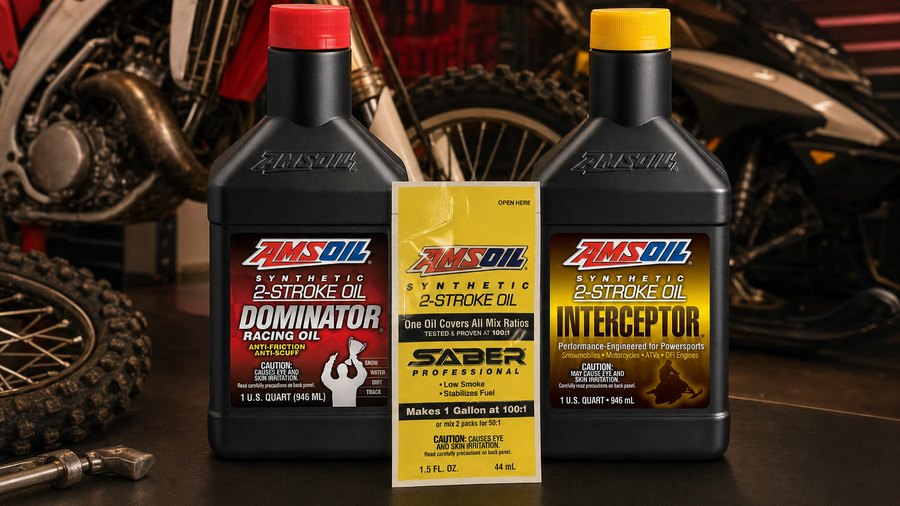 AMSOIL DOMINATOR, INTERCEPTOR, and SABER Professional 2-stroke oils in a powersports garage