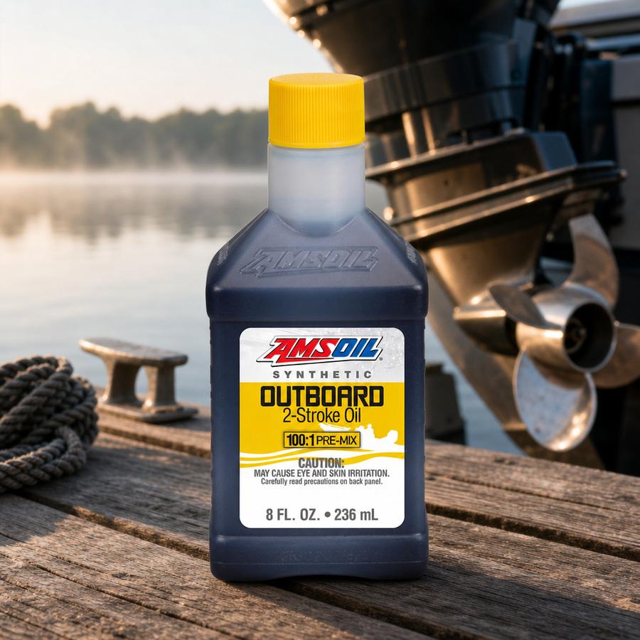 AMSOIL 100:1 Pre-Mix 100% Synthetic 2-Stroke Outboard Oil staged in a marine and boat service setting