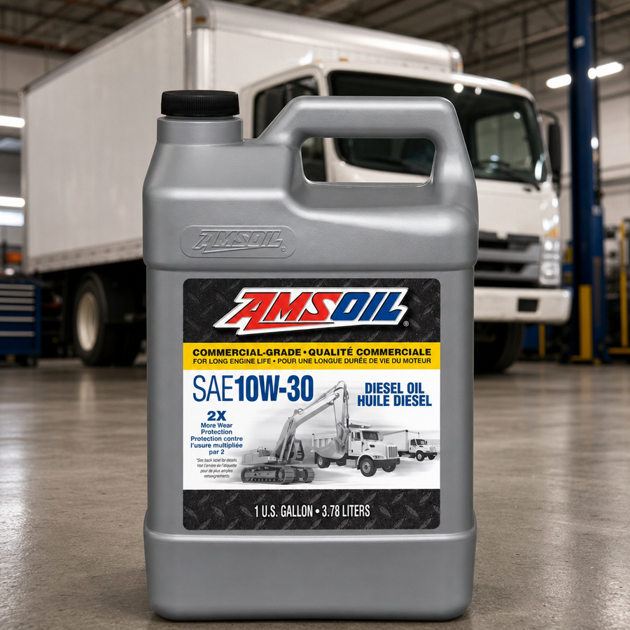 AMSOIL 10W-30 Commercial-Grade Diesel Oil staged in a diesel truck shop
