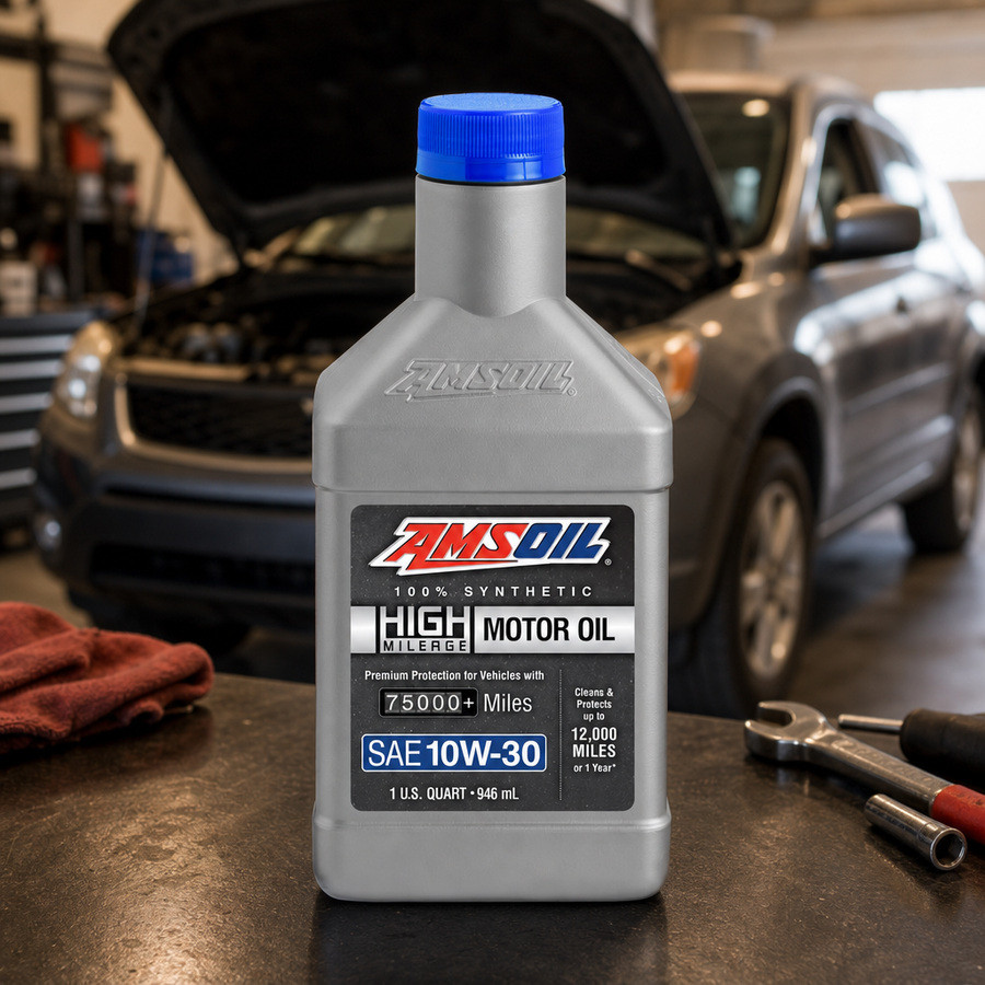 AMSOIL 10W-30 100% Synthetic High-Mileage Motor Oil staged in an automotive service garage