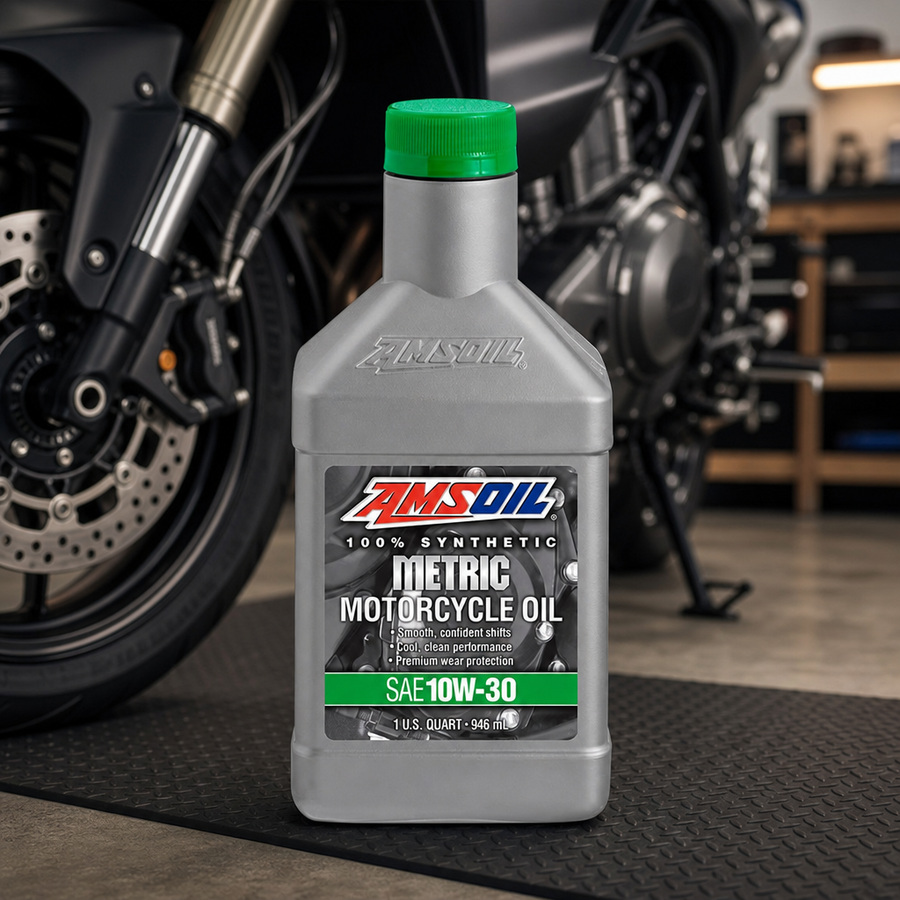 AMSOIL 10W-30 100% Synthetic Metric Motorcycle Oil staged in a sportbike service garage