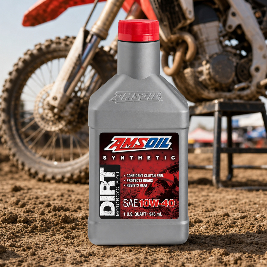 AMSOIL 10W-40 100% Synthetic Dirt Bike Oil staged in a motocross pit area