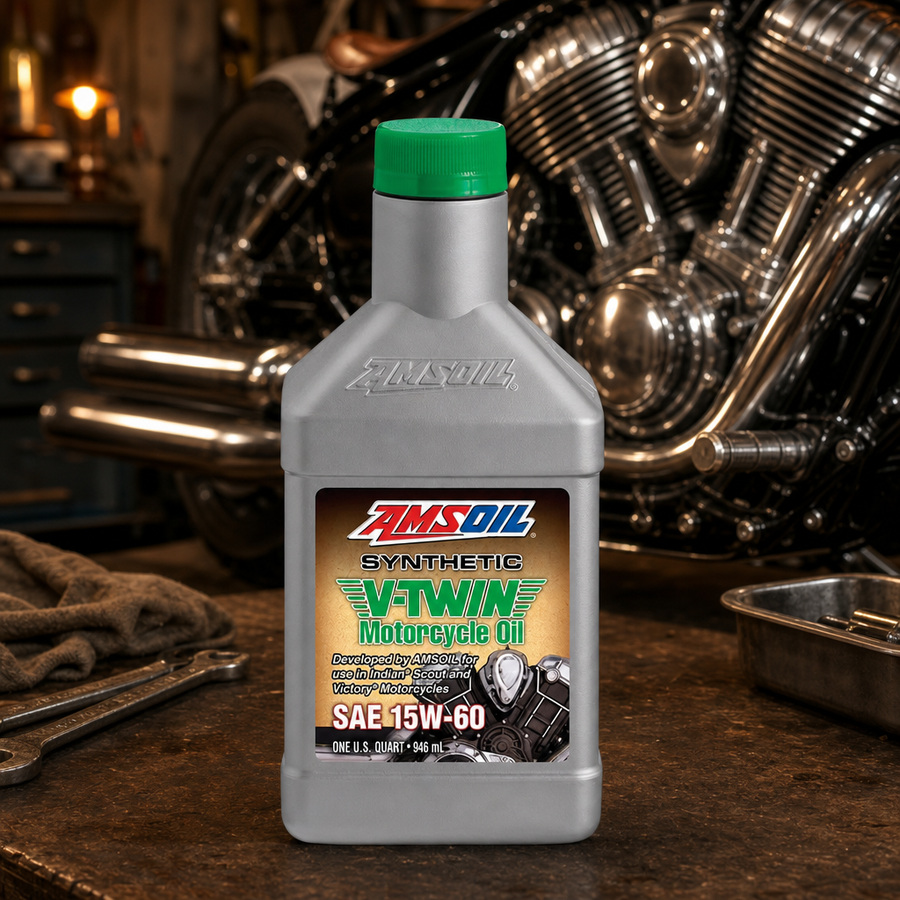 AMSOIL 15W-60 100% Synthetic V-Twin Motorcycle Oil staged in a motorcycle workshop