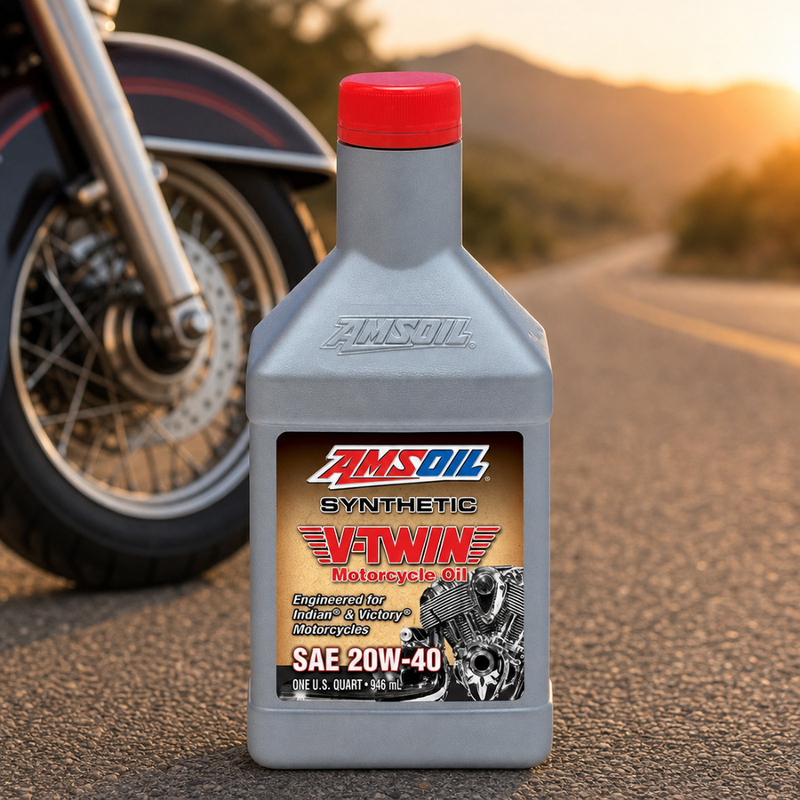 AMSOIL 20W-40 100% Synthetic V-Twin Motorcycle Oil staged in a motorcycle workshop