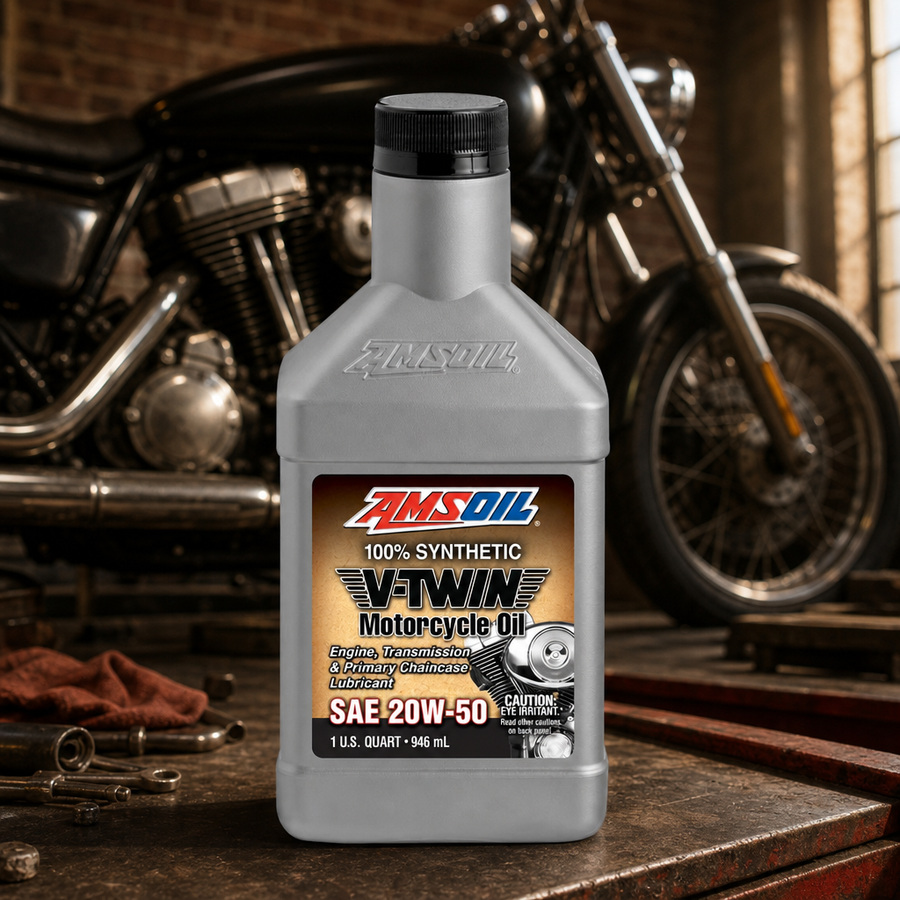 AMSOIL 20W-50 100% Synthetic V-Twin Motorcycle Oil staged in a motorcycle workshop