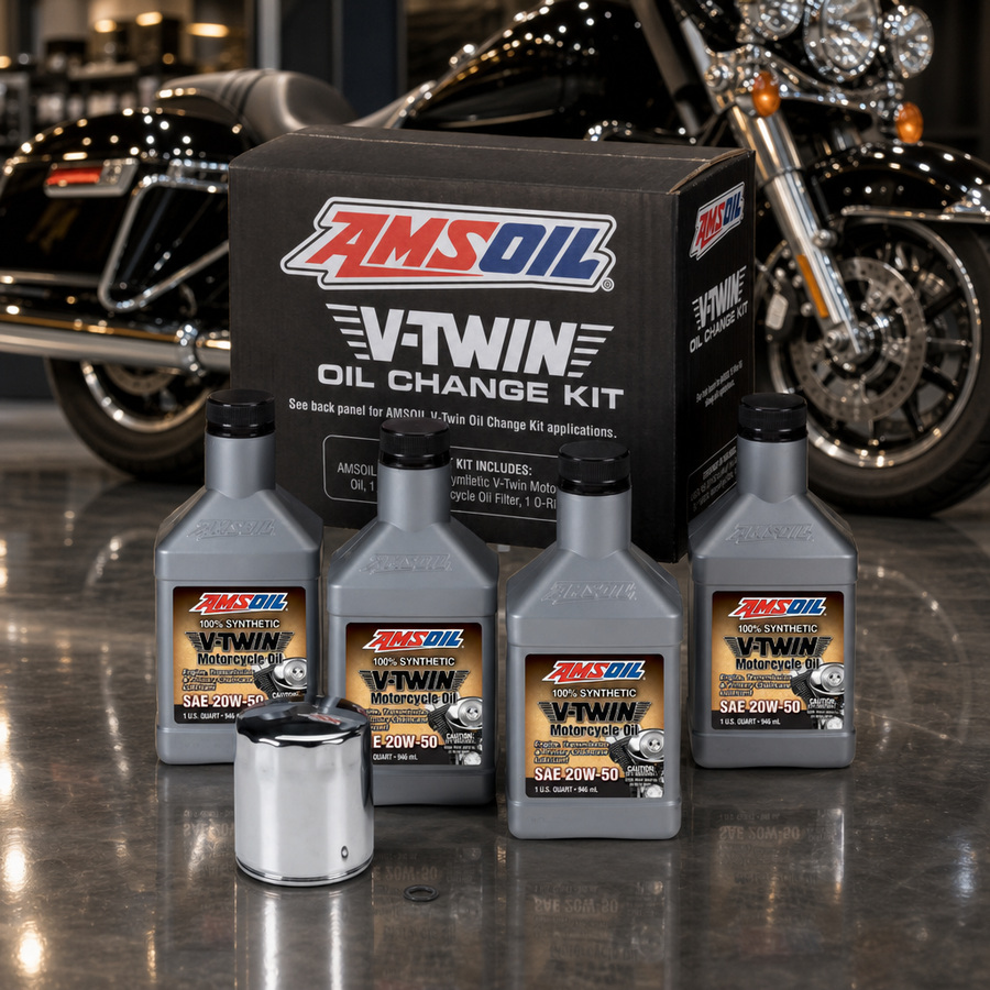AMSOIL 20W-50 Synthetic V-Twin Oil Change Kit - 4 Quarts with Chrome Filter staged in a motorcycle workshop