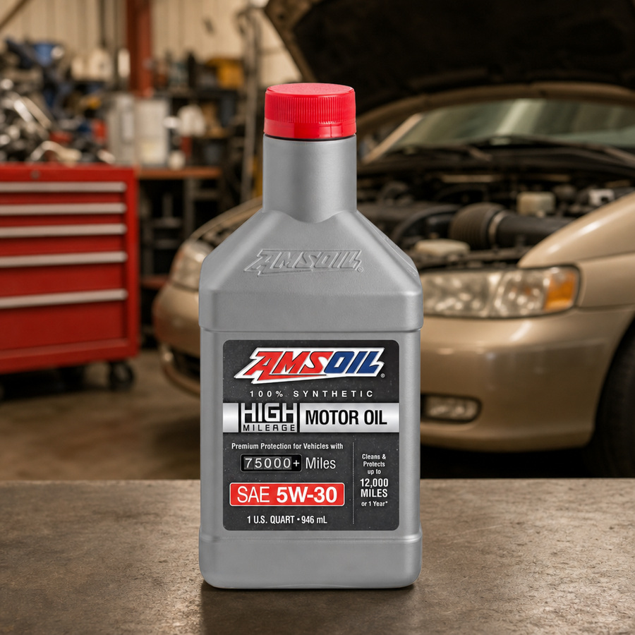 AMSOIL 5W-30 100% Synthetic High-Mileage Motor Oil staged in an automotive service garage