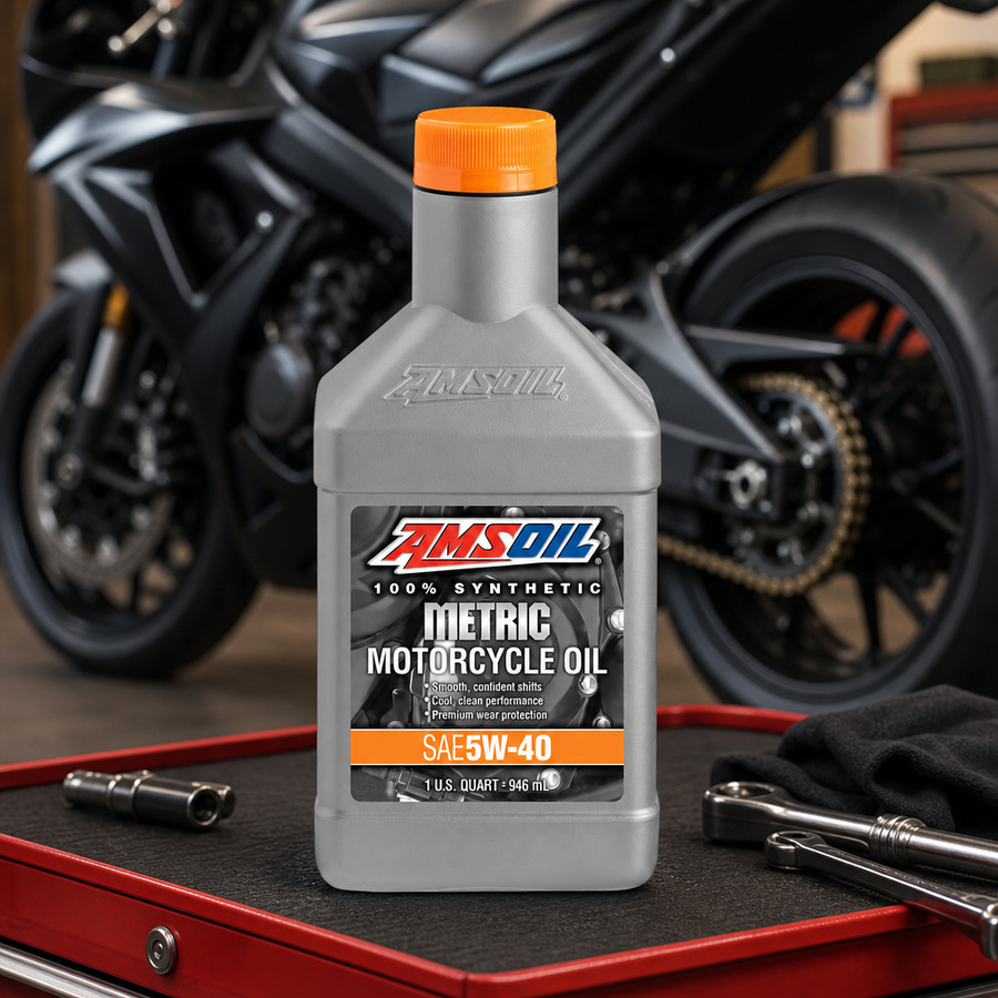 AMSOIL 5W-40 100% Synthetic Metric Motorcycle Oil staged in a sportbike service garage