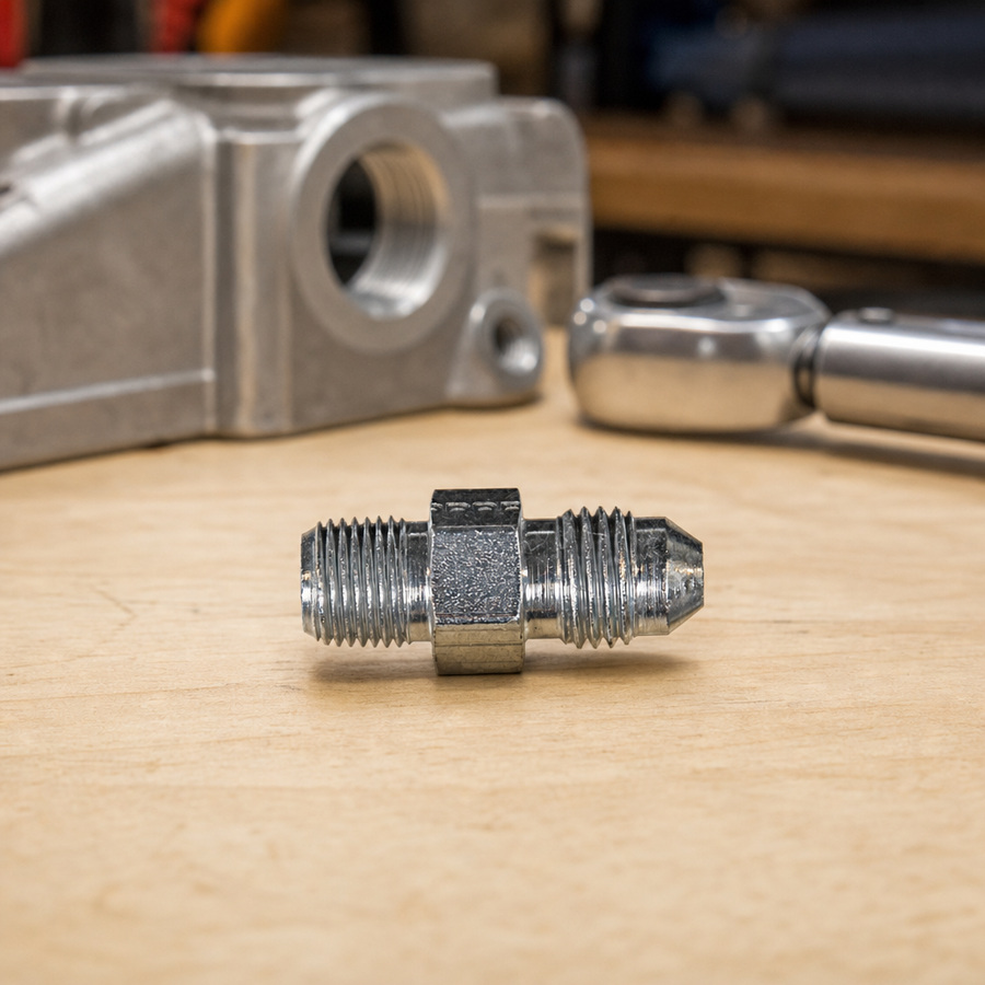 ADAPTER 1/8 MNPT 7/16 JIC staged in a fluid service parts bench
