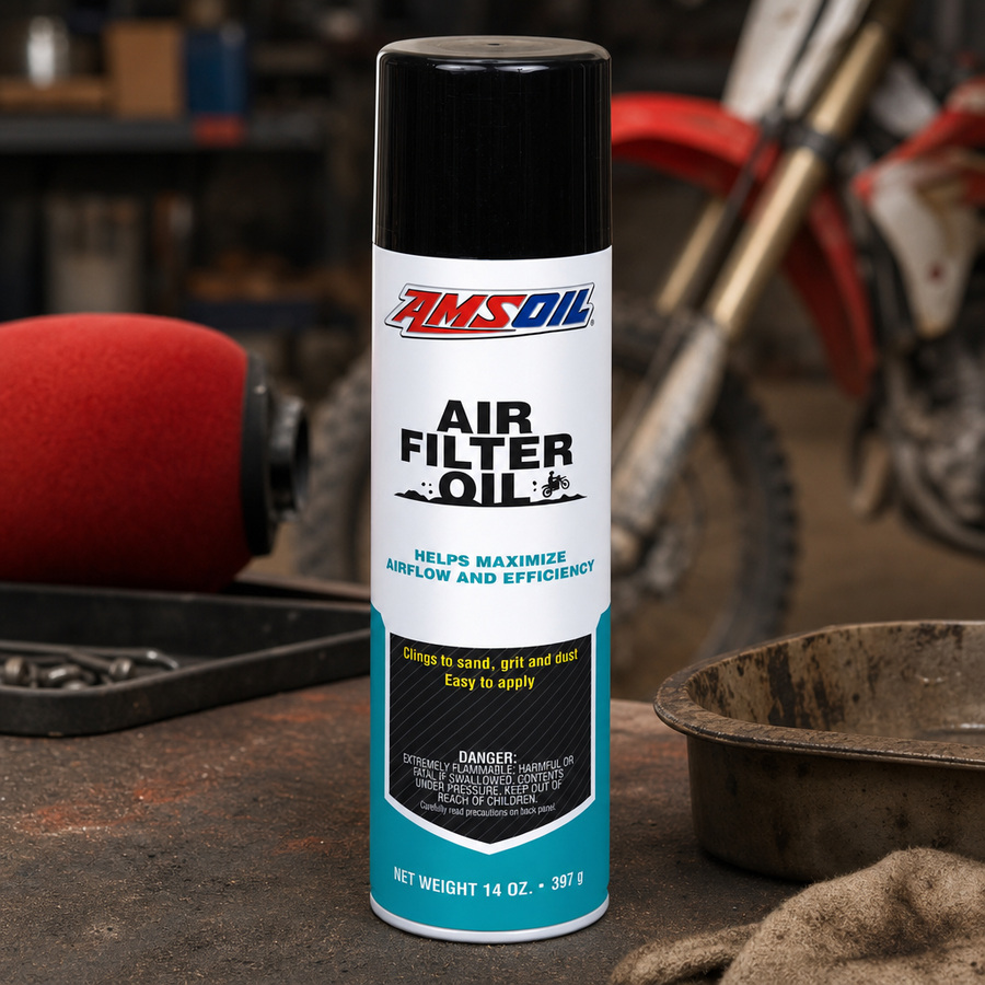 AMSOIL Air Filter Oil staged in an automotive parts workbench
