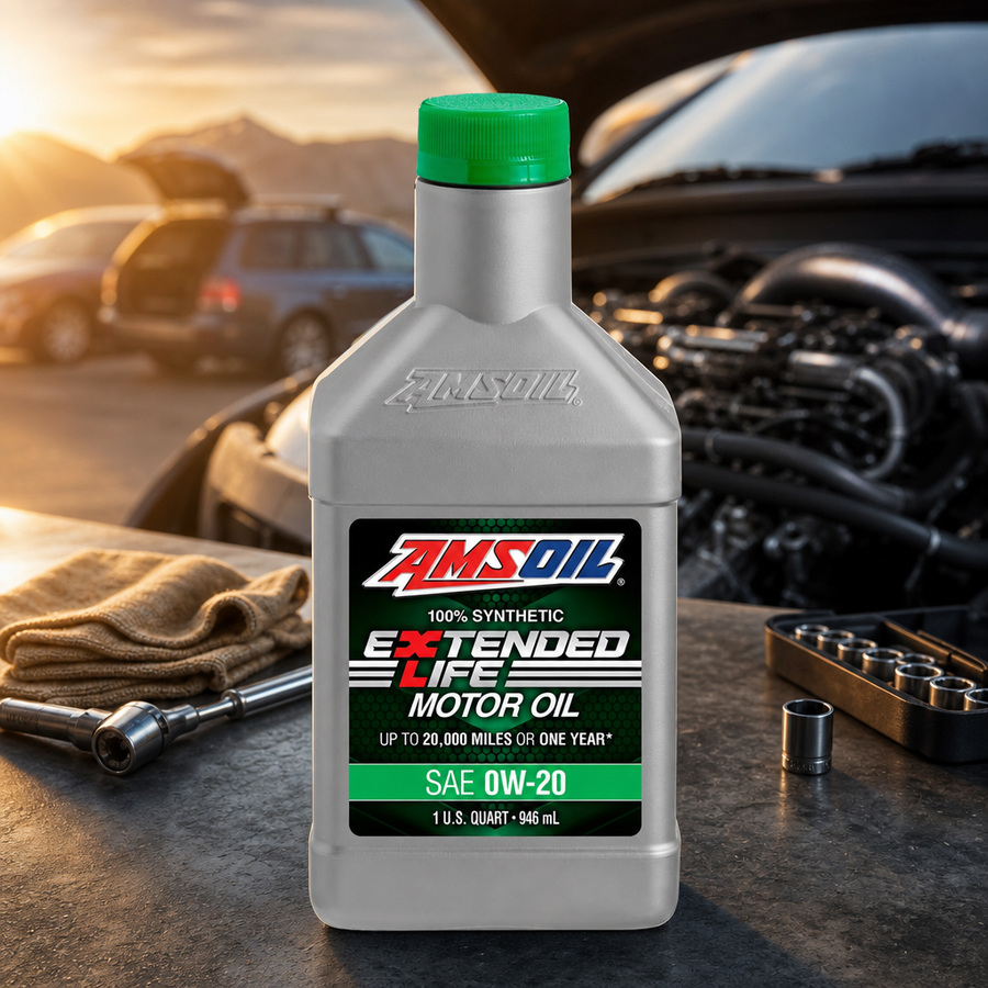 AMSOIL Extended-Life 0W-20 100% Synthetic Motor Oil staged in an automotive service garage