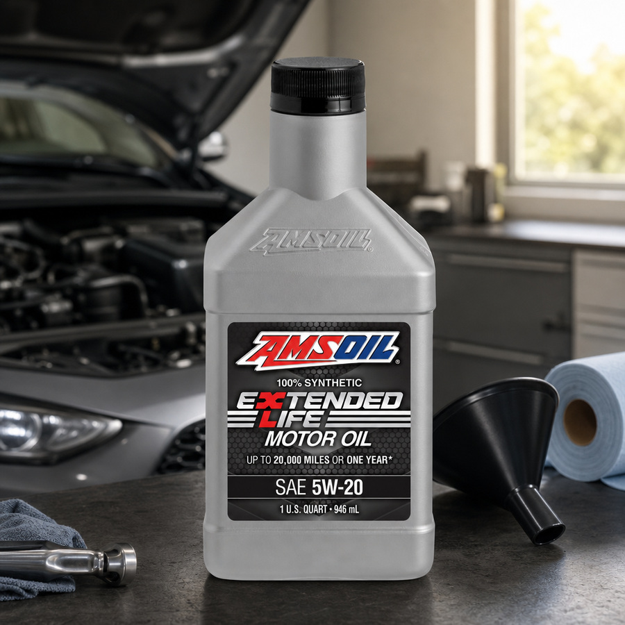 AMSOIL Extended-Life 5W-20 100% Synthetic Motor Oil staged in an automotive service garage