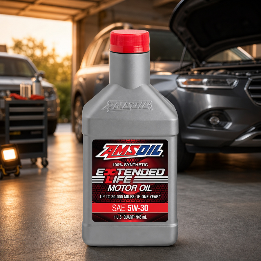 AMSOIL Extended-Life 5W-30 100% Synthetic Motor Oil staged in an automotive service garage