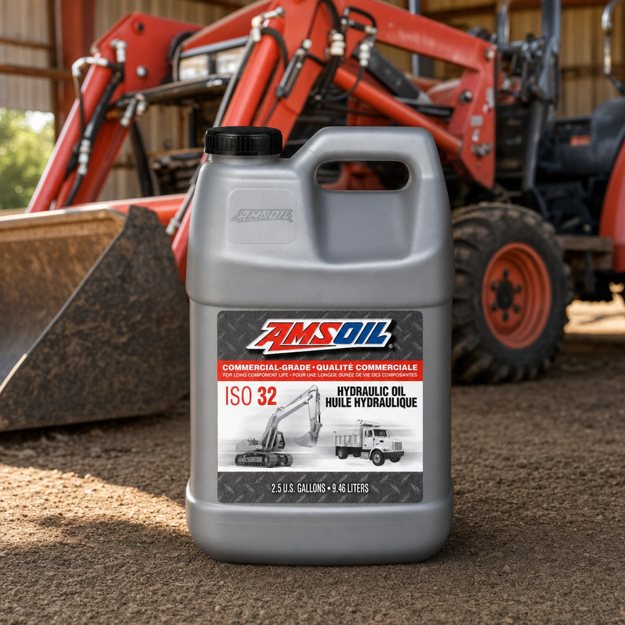 AMSOIL ISO 32 Commercial-Grade Hydraulic Oil staged in an industrial equipment maintenance floor