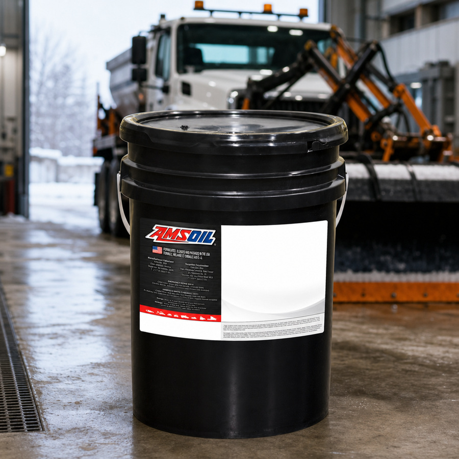 AMSOIL ISO 46 100% Synthetic Multi-Viscosity Hydraulic Oil staged in an industrial equipment maintenance floor