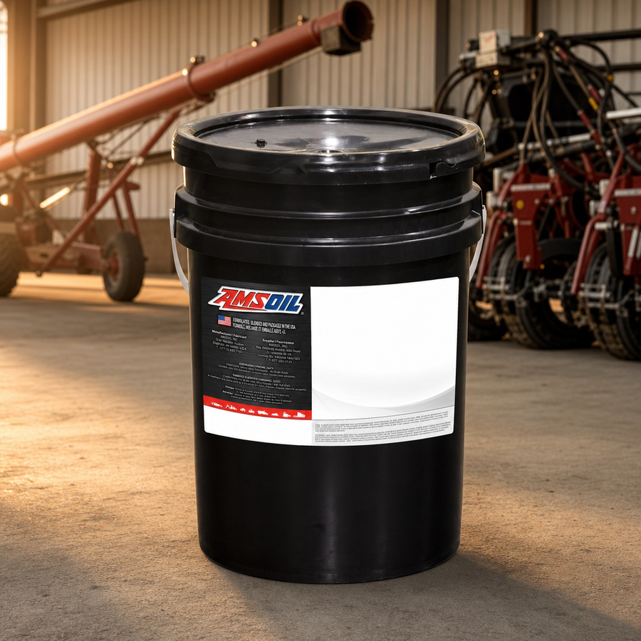 AMSOIL ISO 68 100% Synthetic Multi-Viscosity Hydraulic Oil staged in an industrial equipment maintenance floor