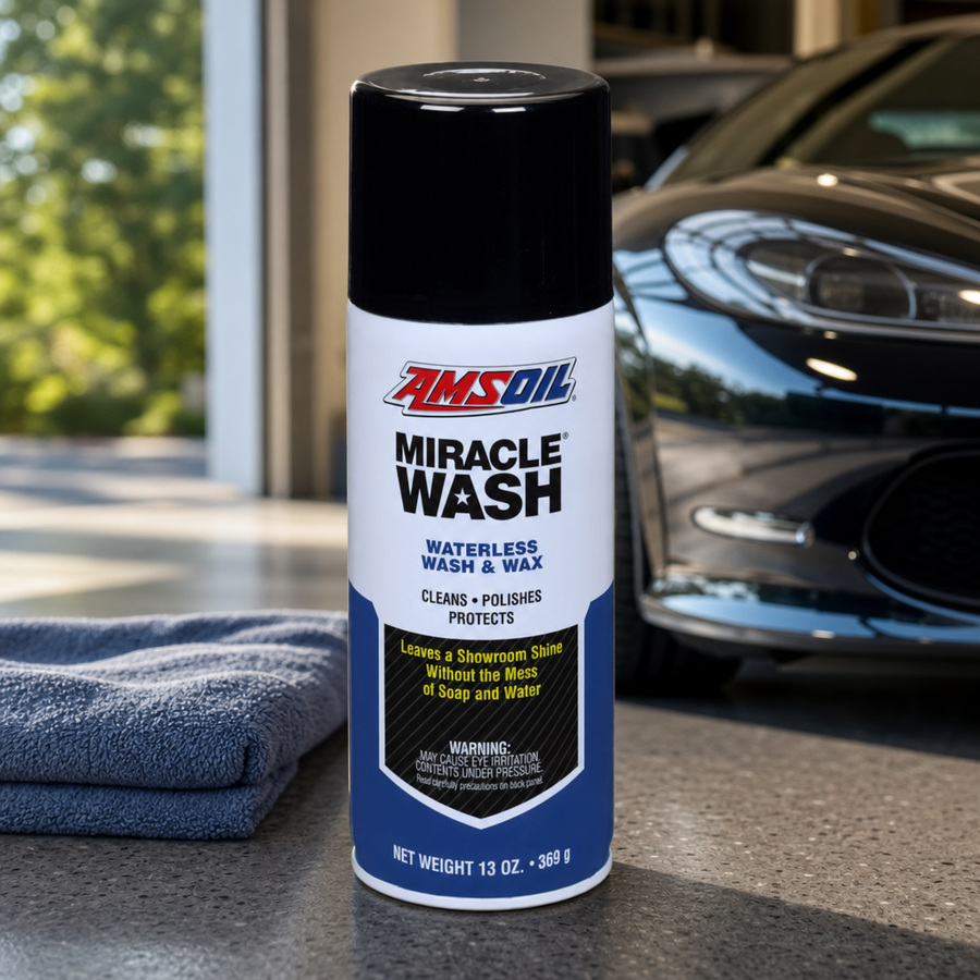 AMSOIL Miracle Wash Waterless Wash and Wax Spray staged in a car detailing bay