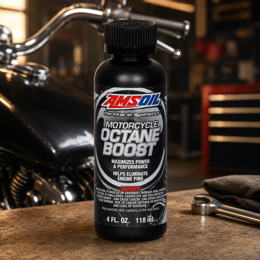 AMSOIL Motorcycle Octane Boost staged in a motorcycle workshop