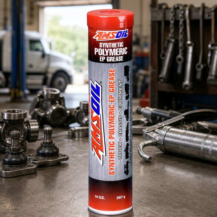 AMSOIL NLGI #2 Synthetic Polymeric Truck, Chassis, and Equipment Grease staged in an equipment maintenance shop