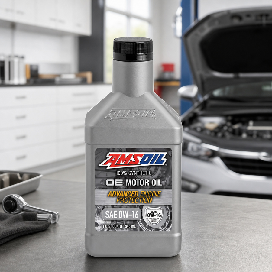 AMSOIL OE 0W-16 100% Synthetic Motor Oil staged in an automotive service garage