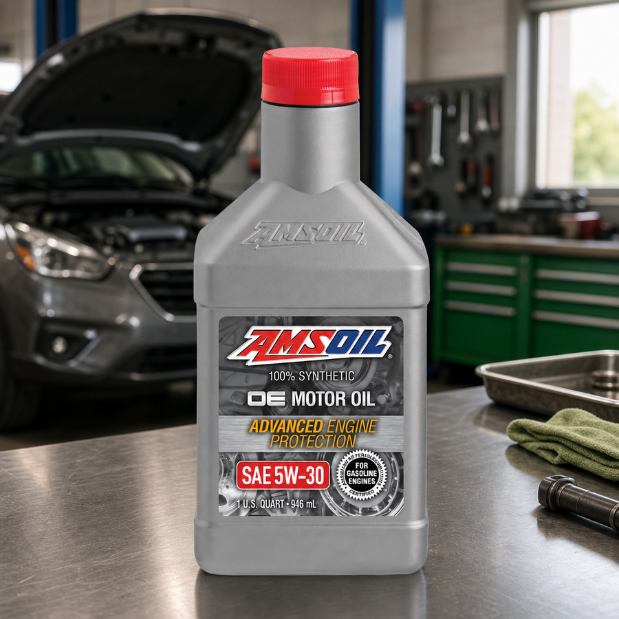 AMSOIL OE 5W-30 100% Synthetic Motor Oil staged in an automotive service garage
