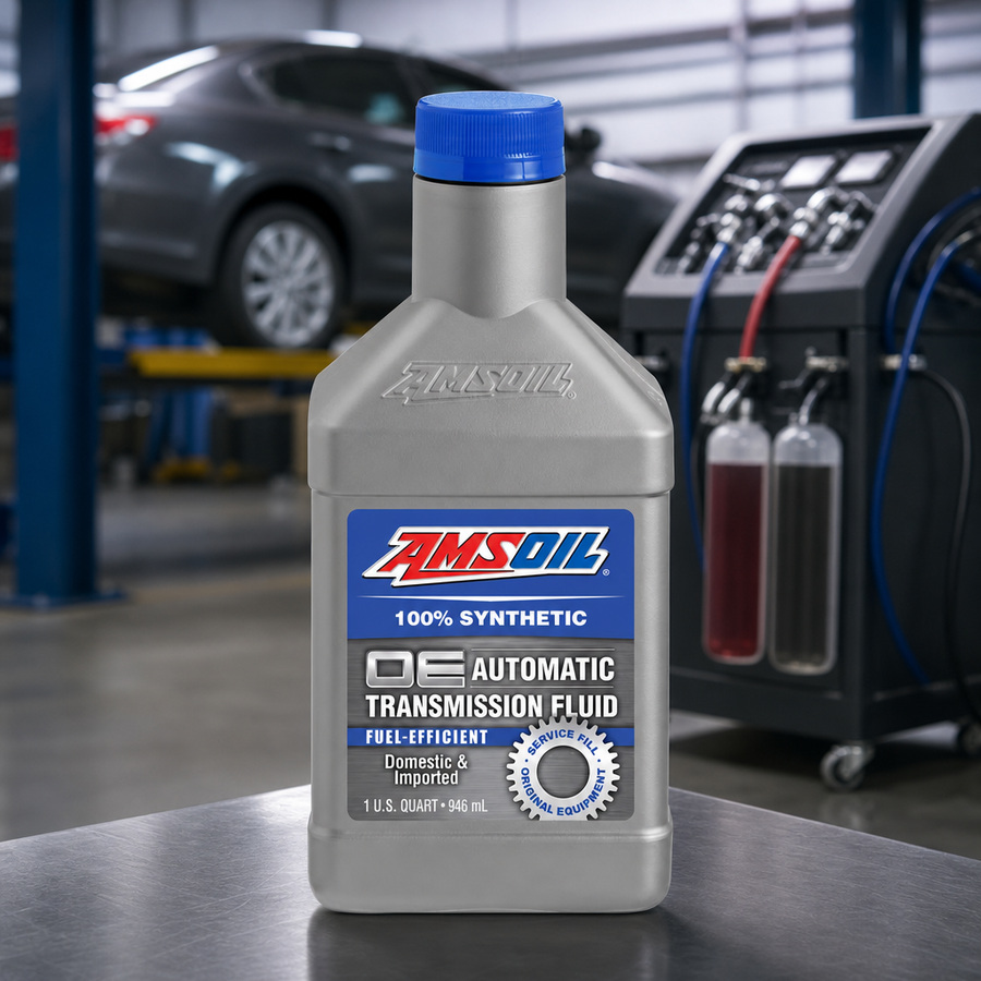 AMSOIL OE Fuel-Efficient 100% Synthetic Automatic Transmission Fluid staged in a transmission service bay