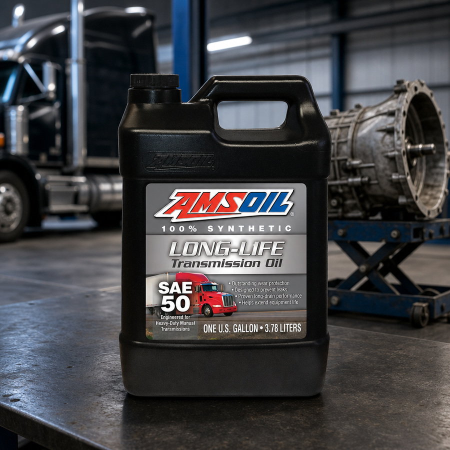 AMSOIL SAE 50 Long Life 100% Synthetic Transmission Oil staged in a transmission service bay