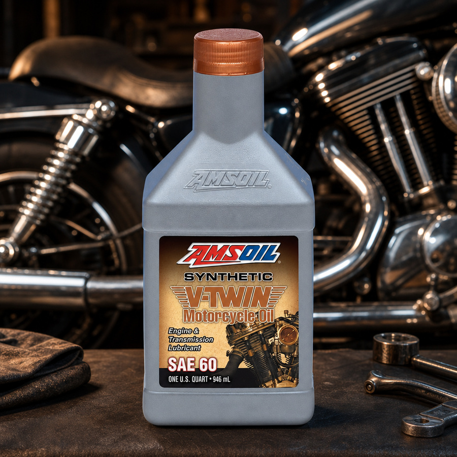 AMSOIL SAE 60 100% Synthetic V-Twin Motorcycle Oil staged in a motorcycle workshop
