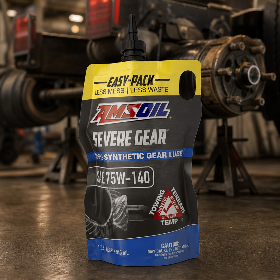 AMSOIL SEVERE GEAR 75W-140 100% Synthetic Gear Lube staged in a drivetrain and gear workshop