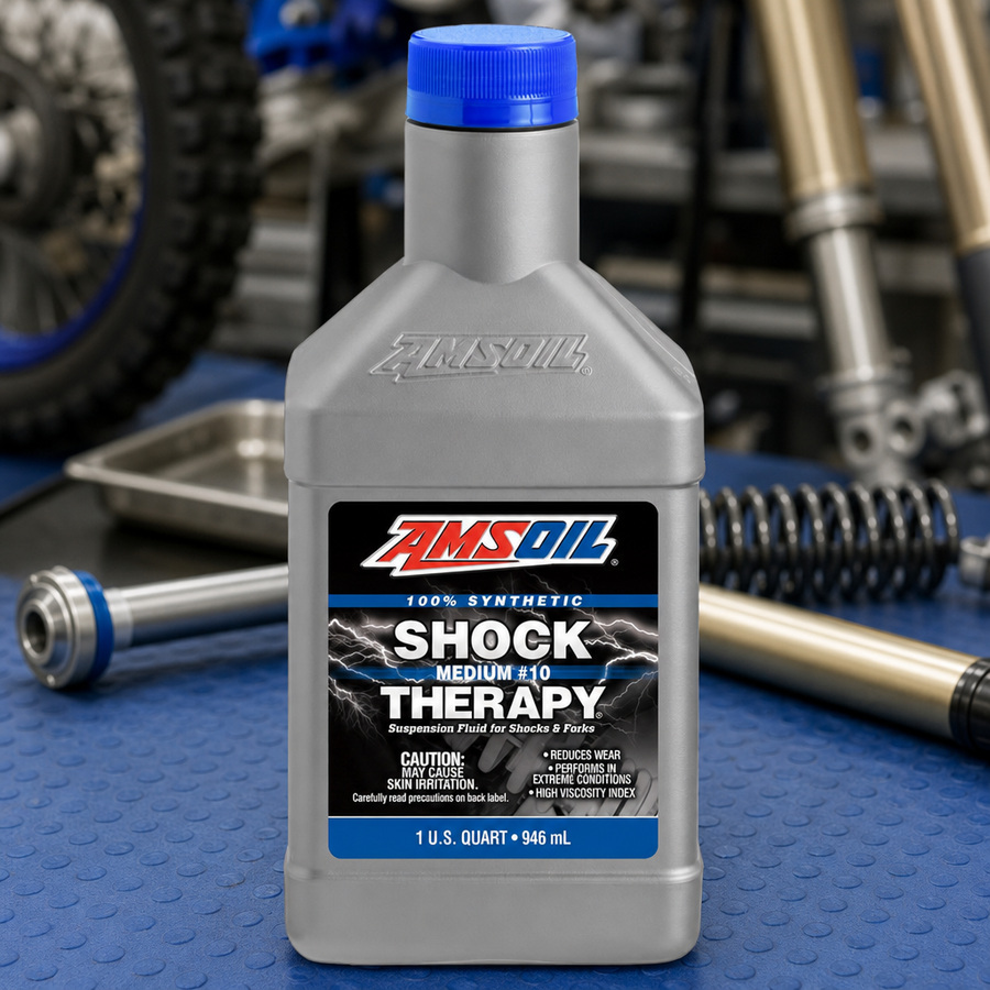 AMSOIL Shock Therapy #10 Medium Suspension Fluid staged in an automotive workshop