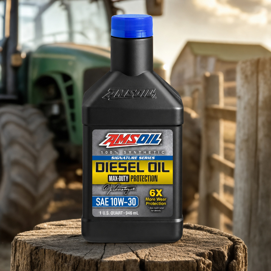 AMSOIL Signature Series 10W-30 100% Synthetic Max-Duty Diesel Oil staged in a diesel truck shop