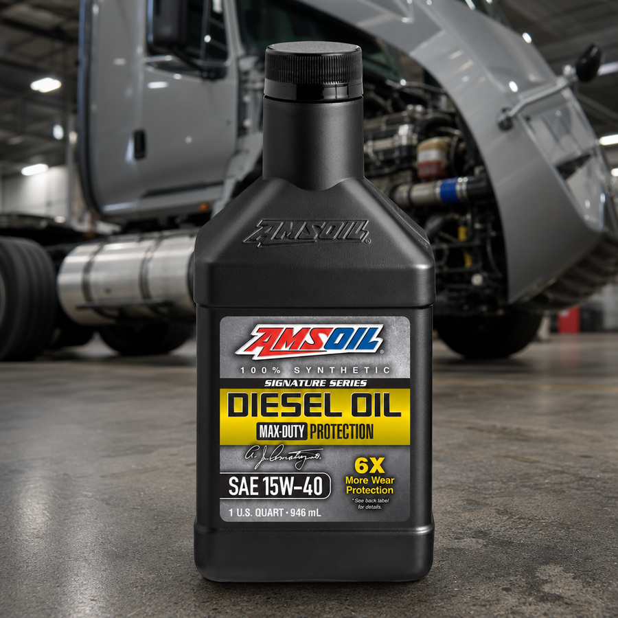 AMSOIL Signature Series 15W-40 100% Synthetic Max-Duty Diesel Oil staged in a diesel truck shop