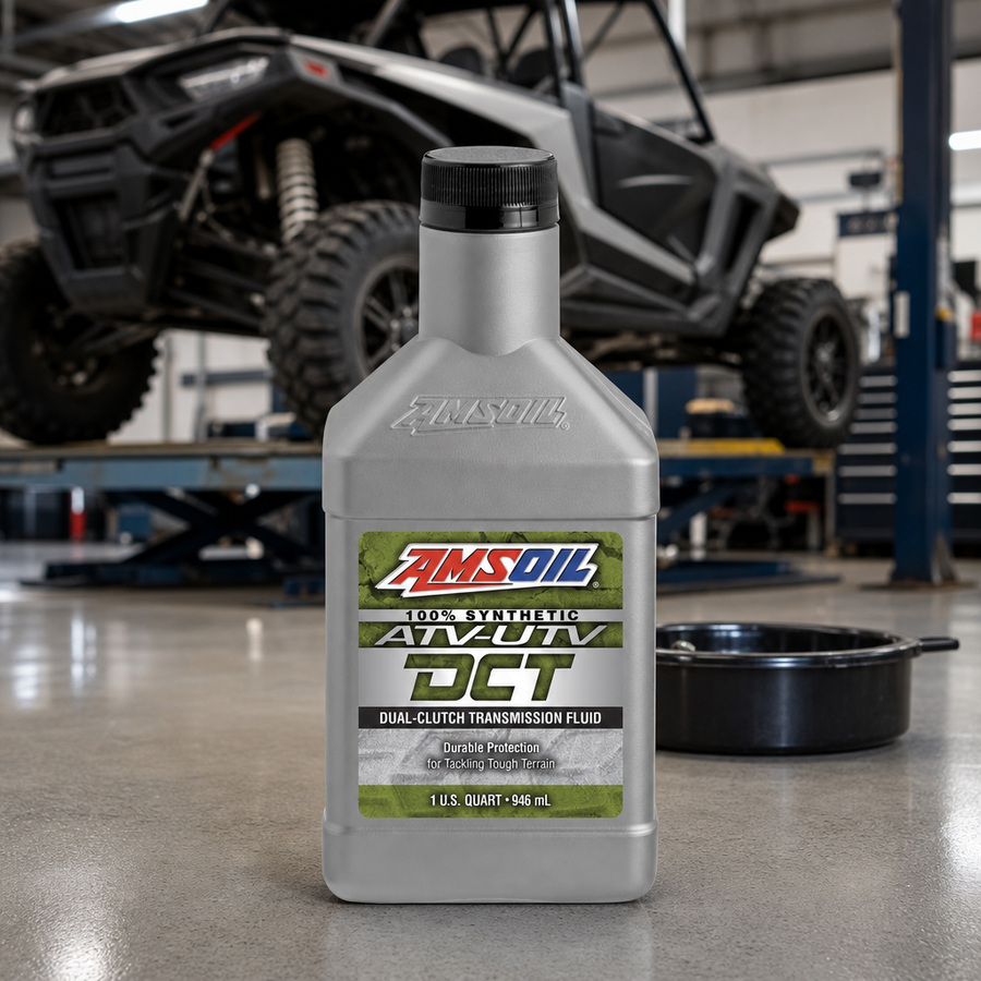 AMSOIL 100% Synthetic ATV/UTV Dual-Clutch Transmission Fluid staged in a powersports service garage