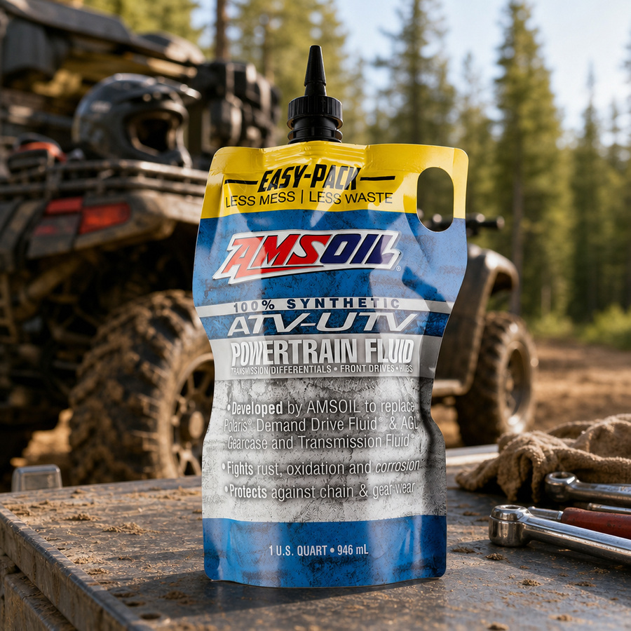 AMSOIL 100% Synthetic ATV/UTV Powertrain Fluid staged in a powersports service garage