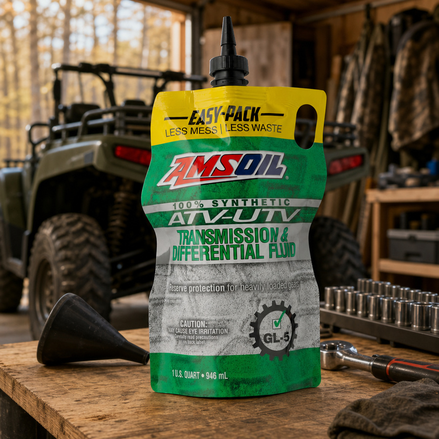 AMSOIL 100% Synthetic ATV/UTV Transmission & Differential Fluid staged in a powersports service garage