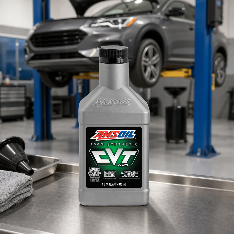 AMSOIL 100% Synthetic CVT Fluid staged in an automotive workshop