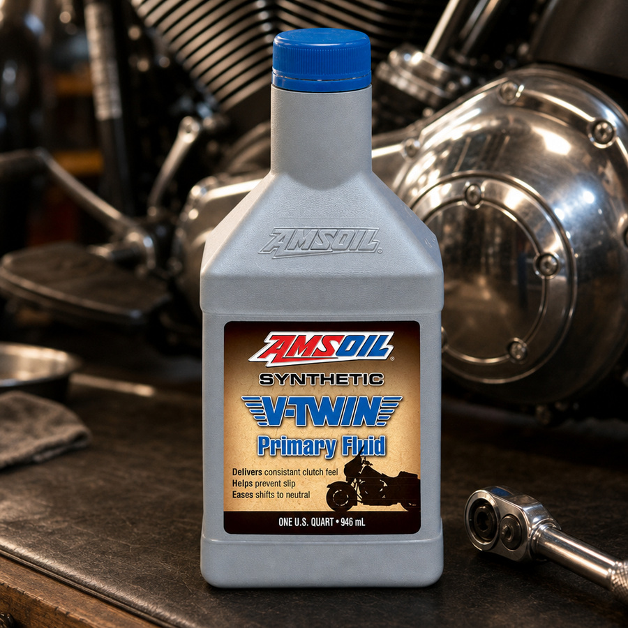 AMSOIL 100% Synthetic V-Twin Primary Fluid staged in a motorcycle workshop