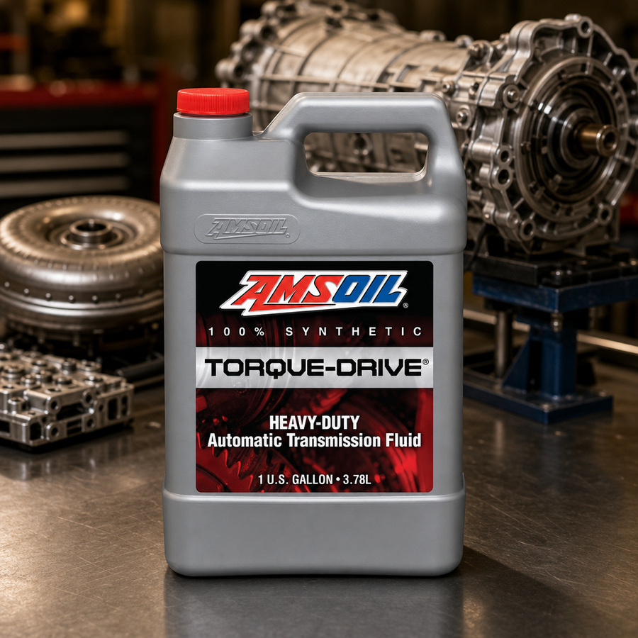 AMSOIL Torque-Drive 100% Synthetic Automatic Transmission Fluid staged in a transmission service bay